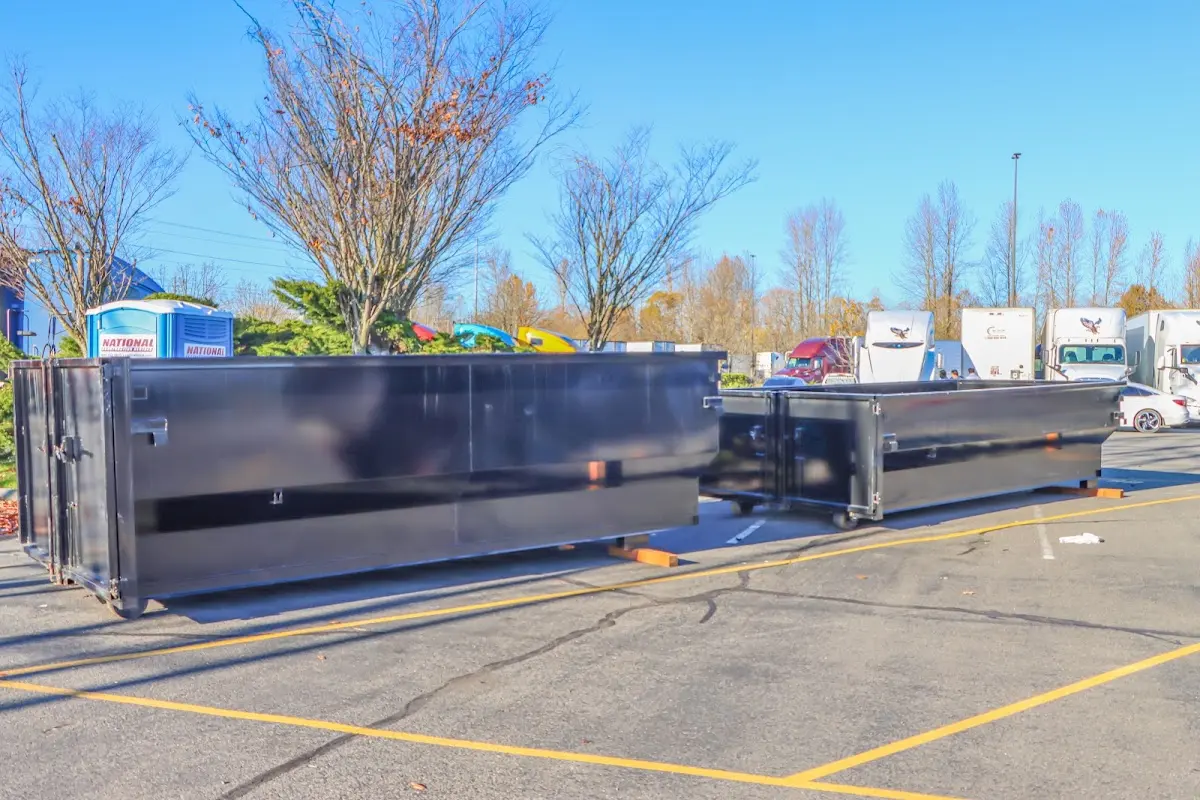 Professional dumpster rental service with roll-off container on residential driveway in Walton